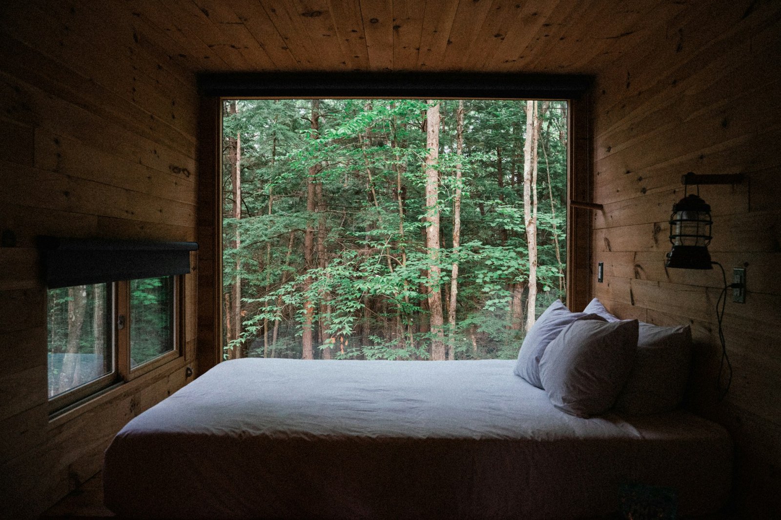 a-bed-sitting-in-a-bedroom-next-to-a-window
